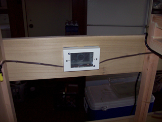 View of fan wiring passing through outlet housing